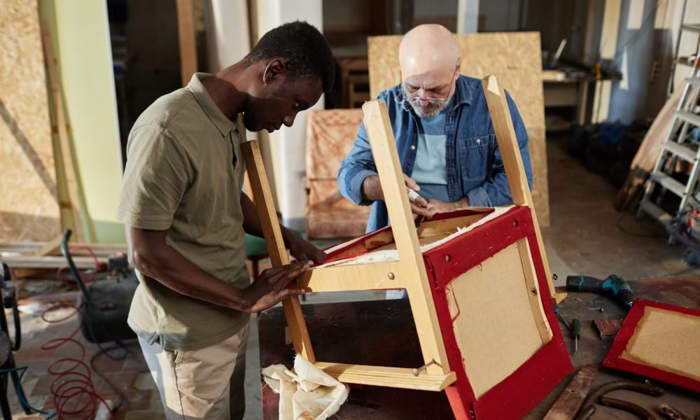 Portrait of two people repairing old furniture while working in carpentry workshop together, copy space SSUCv3H4sIAAAAAAAACpySy24kIQxF95HyDy3WQYIyBcX8ymgW5tWNUl20KCqjUZR/H+rVItvs8LGxry98vr5cLsTgHC35dflcoxrHcVzmkrHENFXM3g6e/eR8bslHBslagLGNvIsl5YhjCw0We5vw7iuclnFc8deWJHPBssx+XrUcyGLx19pjh88Wu+Dfe3w5E1uy3qgpQt4aNi9mYyfam//o5n7481z46if7bxPcLJL96HFf5NBIQCnGmOO0C5JTwXhHNVeGKrB9bzrjQeM5mUihnOkYp72WggoHlg4cDfWq76XSfgAZnsUIQjNEoP1gDRWeS2rMEKiBgJ3rg/Habvp30eT9b/H53pqMi4up8fcjWRzXAmh2wvjAjN/uPXK0cbo2JJXb9kPOTjYtU8mrP09byZjSA824vn+oY/zJbzjPtdydvJlt639M92bOlMrm7tGVuPpN1pADgBoYcC1BV680HAX717rF2meTczaqsX2Prt0qrgpIEPVF6ptRZaGrroZANeuAOuGw1yg7IVh19es/AAAA//8DAMsI5blDAwAA